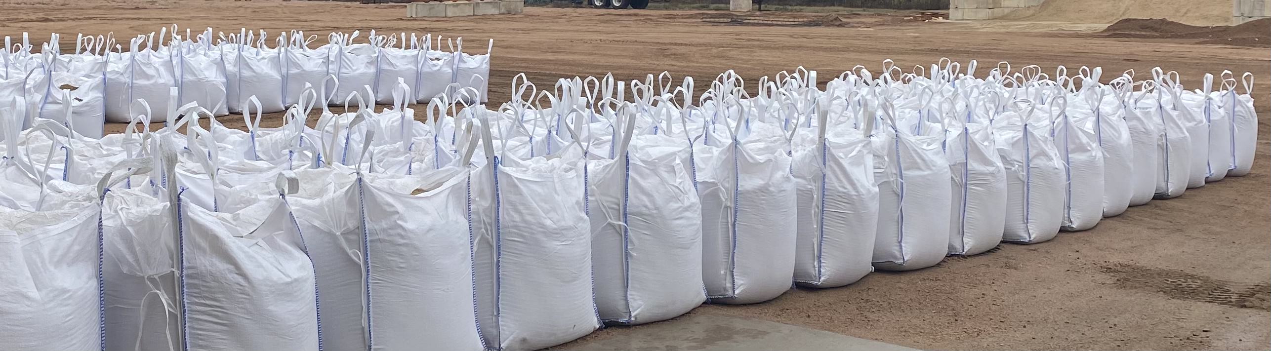 Rows of filled bulk bags in the yard.